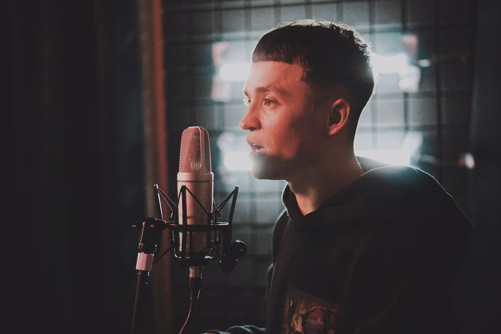 Singer recording vocals in a professional studio